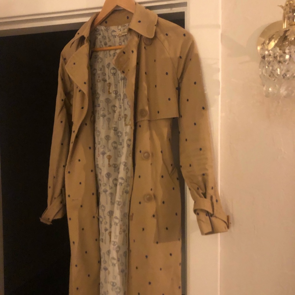 Long khaki trench with navy embroidered polka dots with key printed lining.